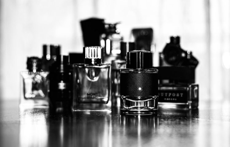 grayscale photo of perfume bottles